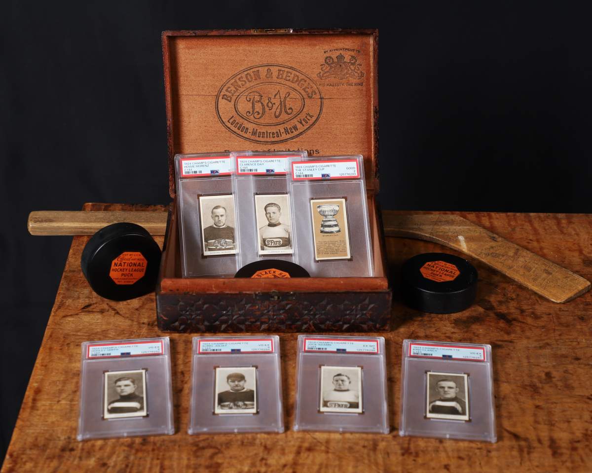 Several 1924 Champs cigarette hockey cards are pictured in a Benson and Hedges cigarette box. 
