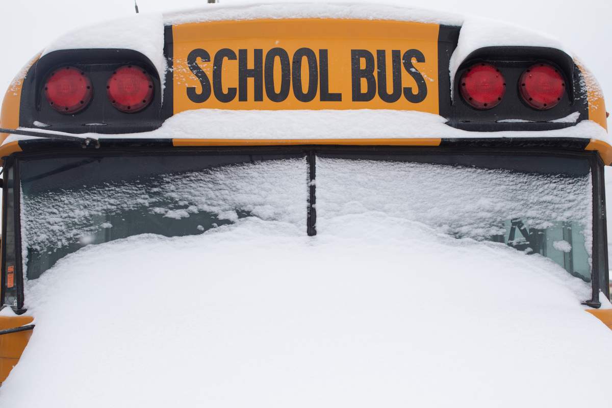 A school bus sits idle after winter conditions suspended the school transportation service in Toronto on Tuesday, Feb. 16, 2021.