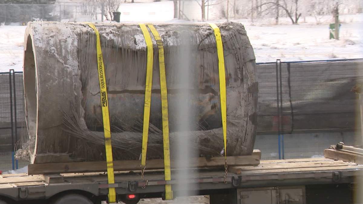 A section of the ruptured Bearspaw Feeder Main sits on a truck in northwest Calgary after crews were able to remove it from the ground on Sunday.
