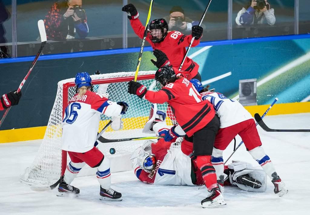 Canada's Julia Gosling (88) and Brianne Jenner (19) celebrate Gosling's goal against Czech Republic goalie Michaela Hesova (1) as Katerina Mrazova (16) watches during the first period of a preliminary round women's hockey game at the Milan Cortina Winter Olympics, in Milan, on Monday, February 9, 2026. THE CANADIAN PRESS/Darryl Dyck.