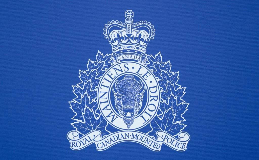 The RCMP logo is seen on the background at a news conference, in St. John's, N.L., Saturday, June 24, 2023. THE CANADIAN PRESS/Adrian Wyld.