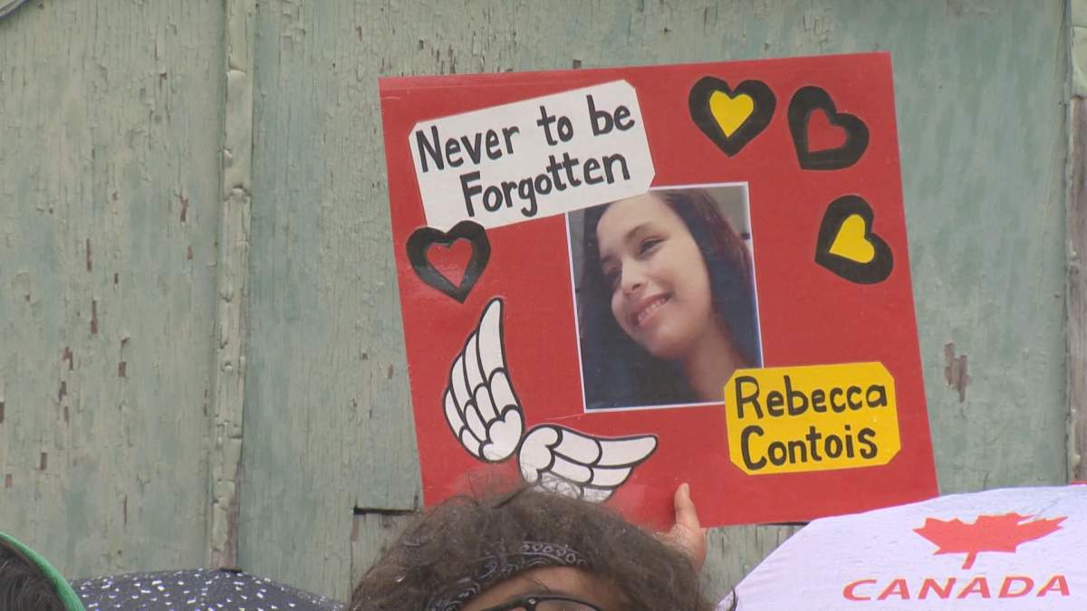 Mourners gathered in the rain at a memorial for Rebecca Contois in May 2022.