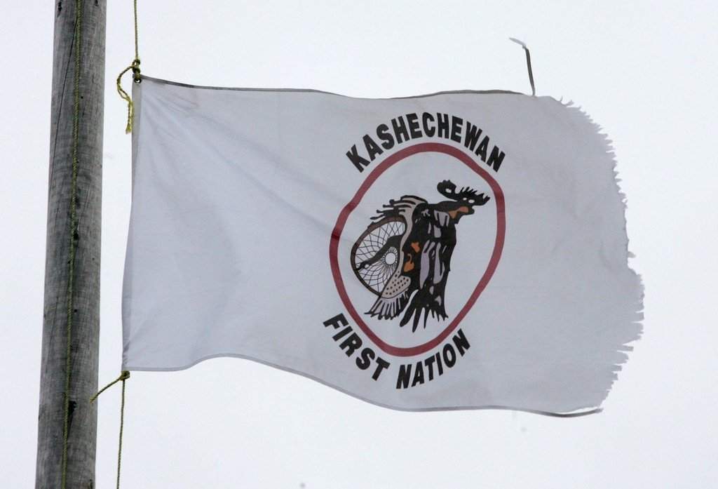 A Kashechewan First Nation flag flies outside St. Paul's Anglican church in northern Ontario, Sunday, Oct. 30, 2005.  THE CANADIAN PRESS/Jonathan Hayward.
