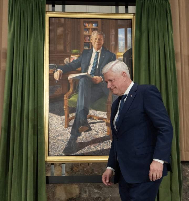 Former prime minister Stephen Harper walks past his official portrait as he makes his way to the podium during a ceremony in Ottawa, on Tuesday, Feb 3, 2026. THE CANADIAN PRESS/Adrian Wyld