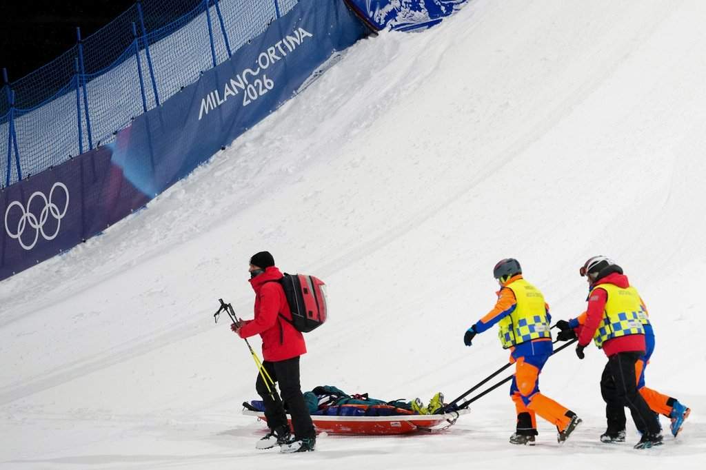 Medics stretcher off Switzerland's Mathilde Gremaud after she crashed during practice before the women's freestyle skiing big air finals at the 2026 Winter Olympics, in Livigno, Italy, Monday, Feb. 16, 2026. (AP Photo/Abbie Parr).