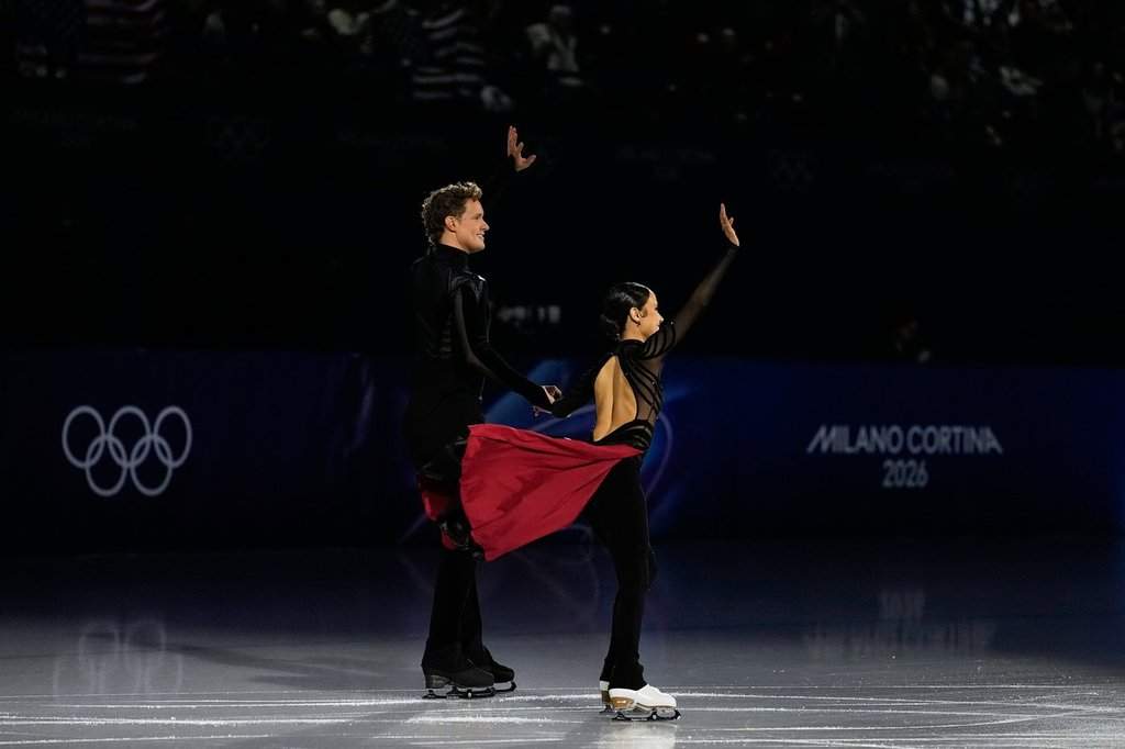Madison Chock and Evan Bates of the United States wave to the crowd before the figure skating ice dance team event at the 2026 Winter Olympics, in Milan, Italy, Saturday, Feb. 7, 2026.