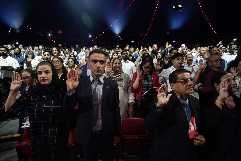 A section of the nearly 400 new Canadians from 65 countries, take an oath of citizenship at a ceremony in Toronto on Friday, July 19, 2024. THE CANADIAN PRESS/Chris Young.