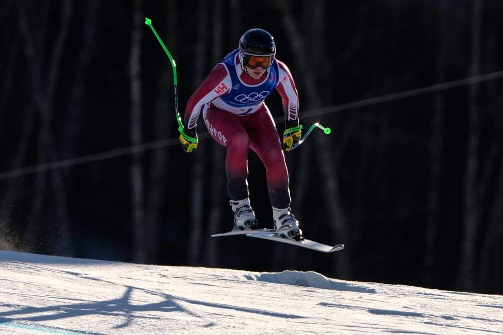 Canada's James Crawford speeds down the course during an alpine ski, men's downhill race, at the 2026 Winter Olympics, in Bormio, Italy, Saturday, Feb. 7, 2026. (AP Photo/John Locher).