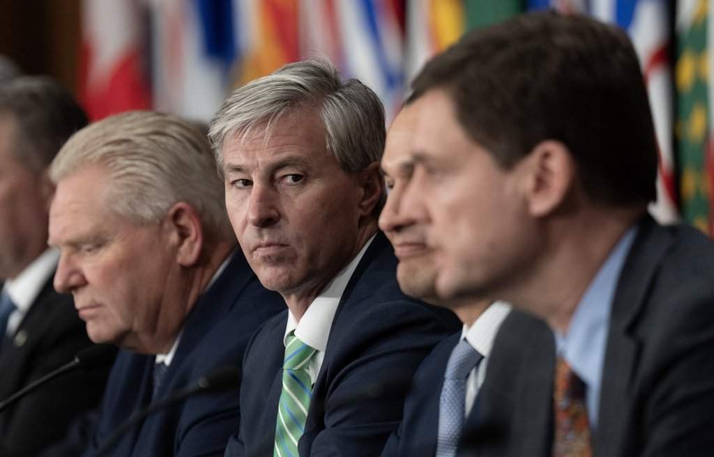 Nova Scotia Premier Tim Houston, centre, look toward at B.C. Premier David Eby as he speaks during a news conference following the First Ministers Meeting in Ottawa, Thursday, Jan. 29, 2026. THE CANADIAN PRESS/Adrian Wyld.