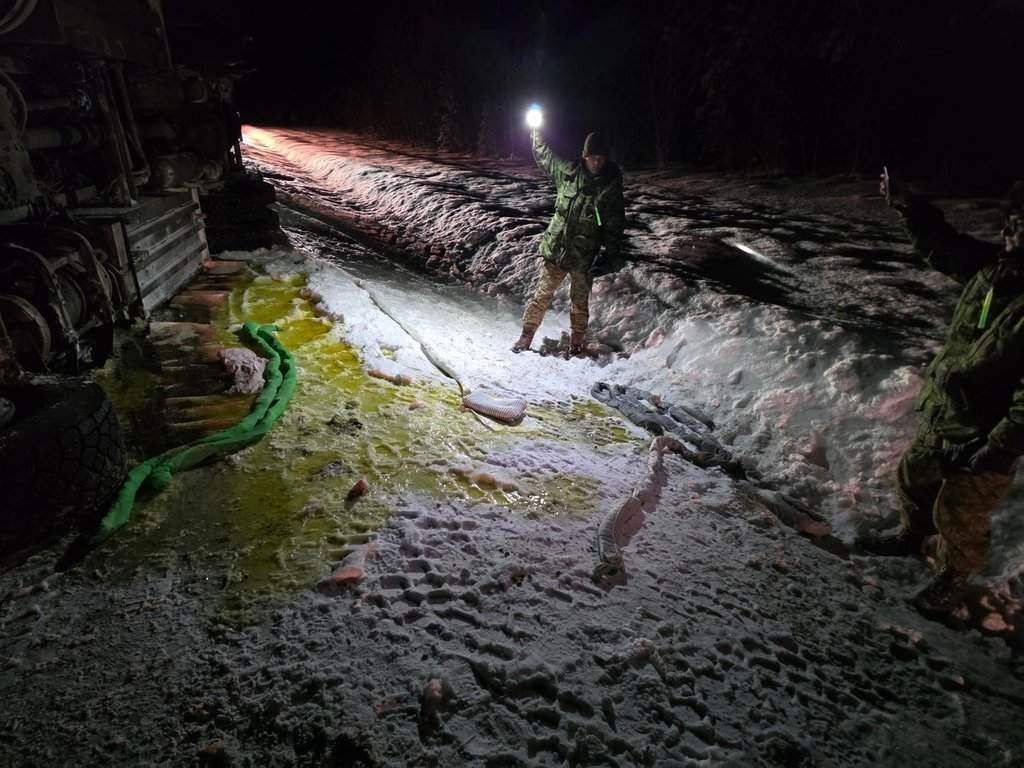 Canadian Armed Forces personnel examine the scene after a military fuel tanker filled with thousands of litres of diesel overturned on a highway near Kakisa, N.W.T. in this Monday, Feb. 9, 2026 handout photo. 