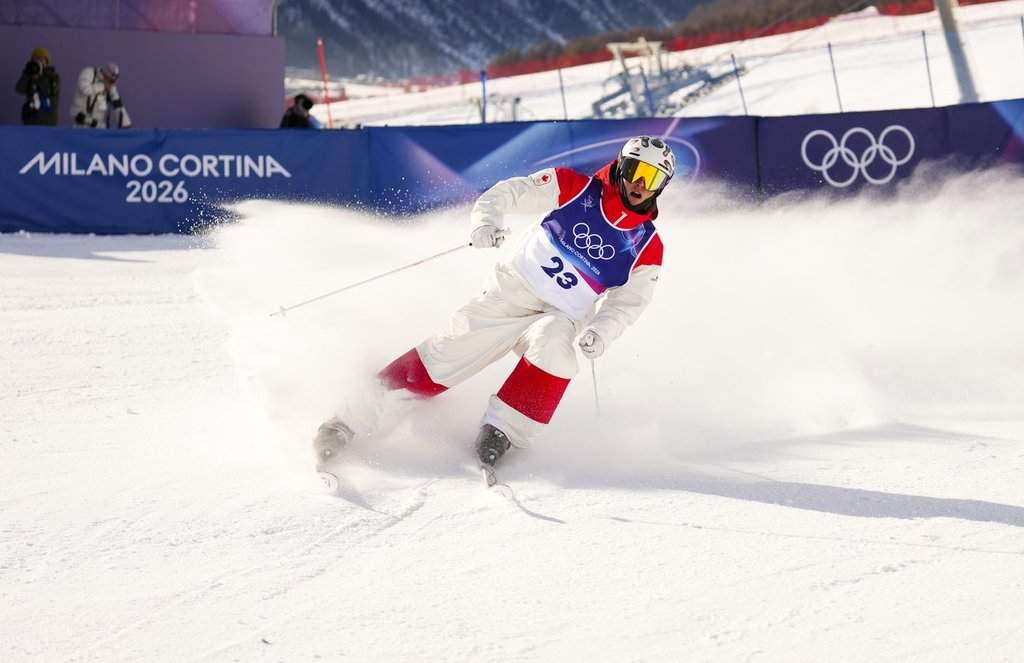 Elliot Vaillancourt from Drummondville, Que., slides into the finish zone as he competes in the men's moguls qualification two at the Milano Cortina 2026 Winter Olympic Games in Livigno, Italy on Thursday, Feb. 12, 2026. THE CANADIAN PRESS/Sean Kilpatrick.
