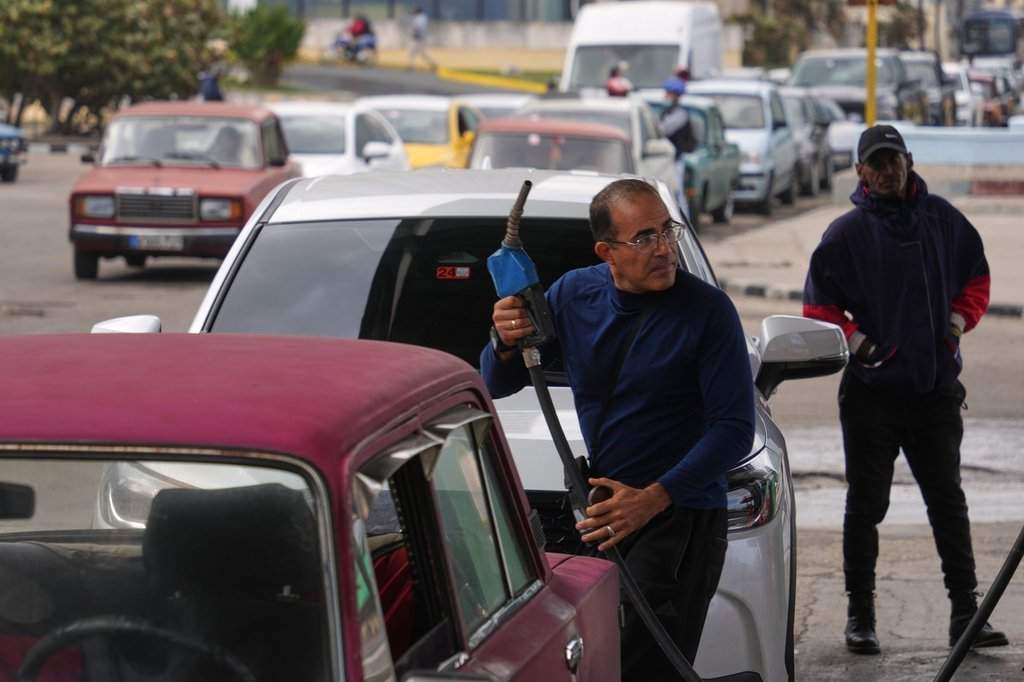 Fuel shortages have rocked the Cuban economy since the U.S. blocked shipments of oil from Venezuela to the Caribbean nation. Sherritt International is blaming the energy crunch for its decision to suspend operations at its Fort Saskatchewan refinery, which processes nickel and cobalt from the company's Moa mine joint venture in Cuba. In this photo, a driver refuels as others wait in a long line behind to fill up at a gas station in Havana, Cuba, Tuesday, Jan. 27, 2026. (AP Photo/Ramon Espinosa).