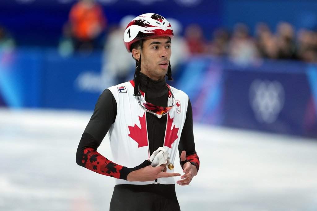 Canada's William Dandjinou finishes fourth after competing in the men's 1,000 metre short track speedskating finals at the 2026 Winter Olympics, in Milan, on Thursday, February 12, 2026. THE CANADIAN PRESS/Darryl Dyck.