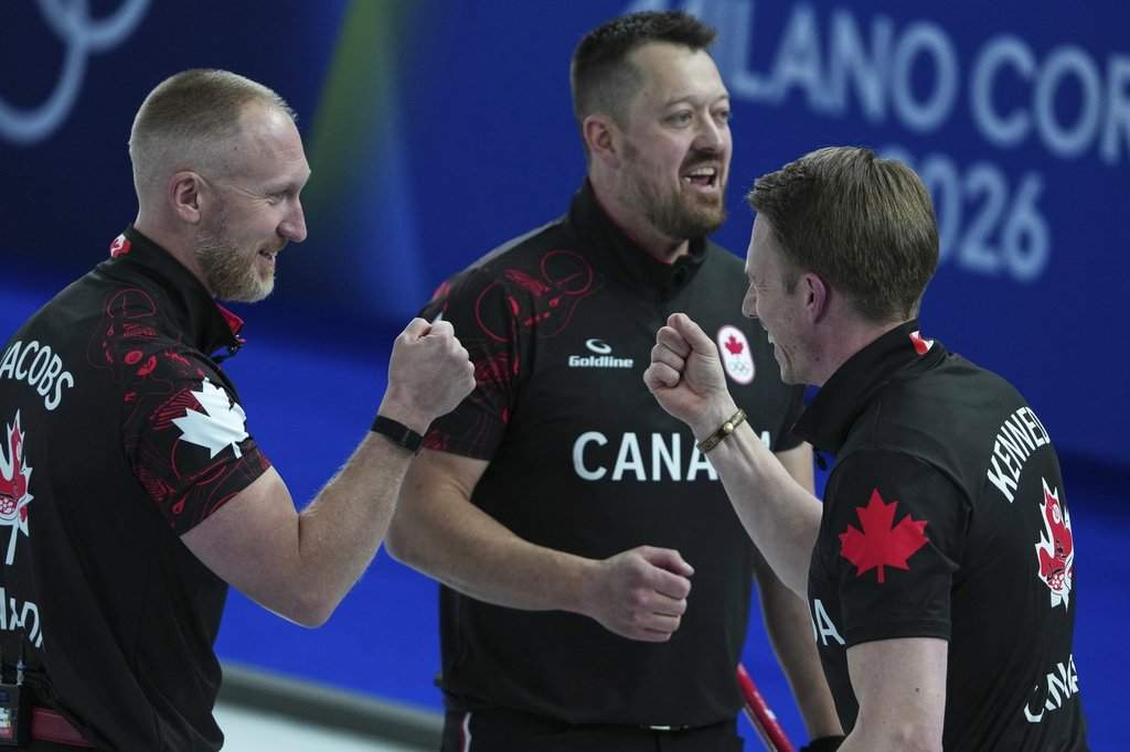 Canada's Marc Kennedy, Brad Jacobs, and Ben Hebert react after the men's curling round robin session against Sweden, at the 2026 Winter Olympics, in Cortina d'Ampezzo, Italy, Friday, Feb. 13, 2026. (AP Photo/Misper Apawu).