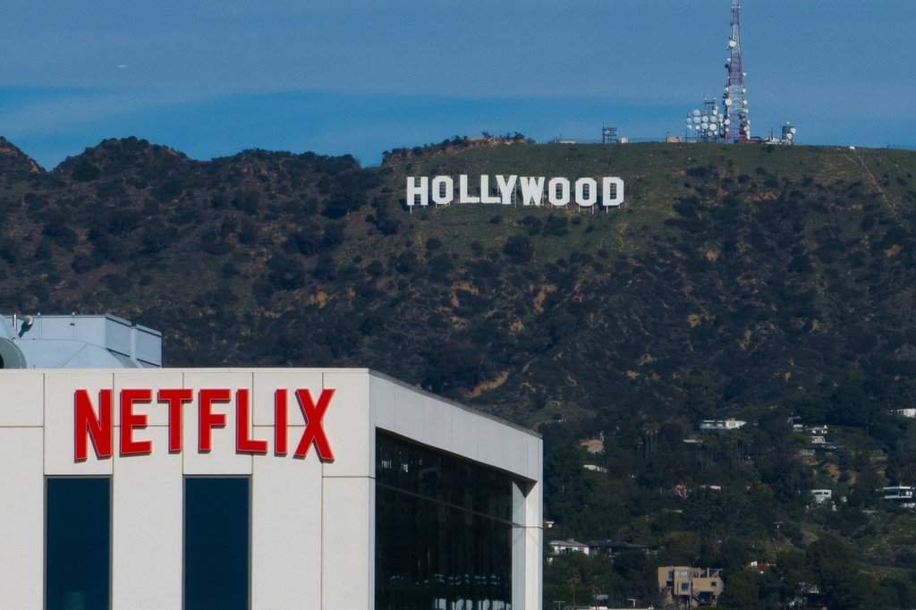 FILE - A Netflix sign is displayed atop a building in Los Angeles, on Dec. 18, 2025, with the Hollywood sign in the distance