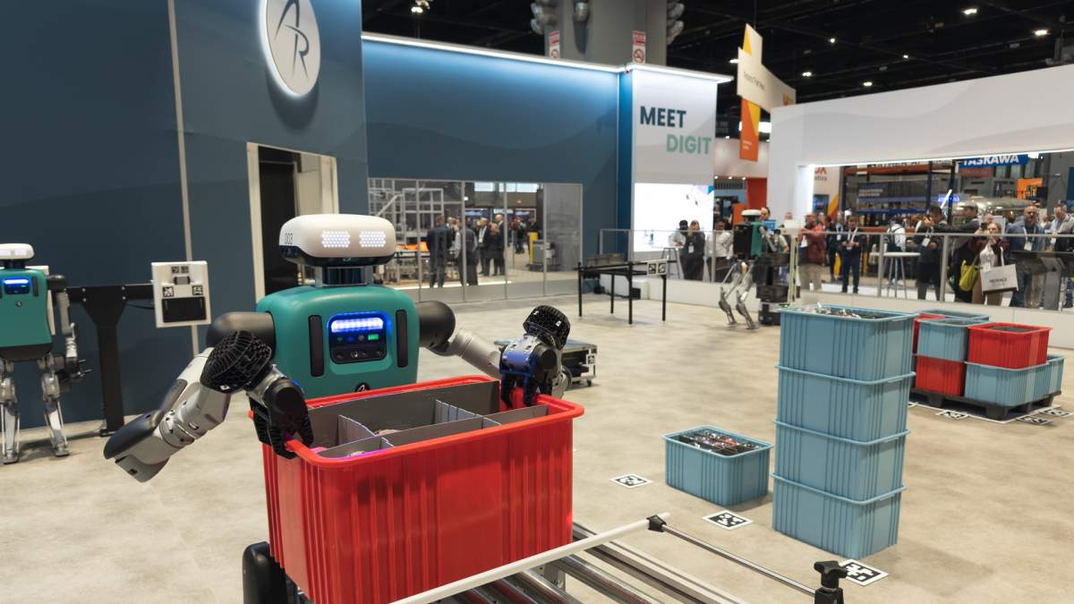Digit, a humanoid robot developed by Agility Robotics, performs material-handling tasks inside a manufacturing facility.