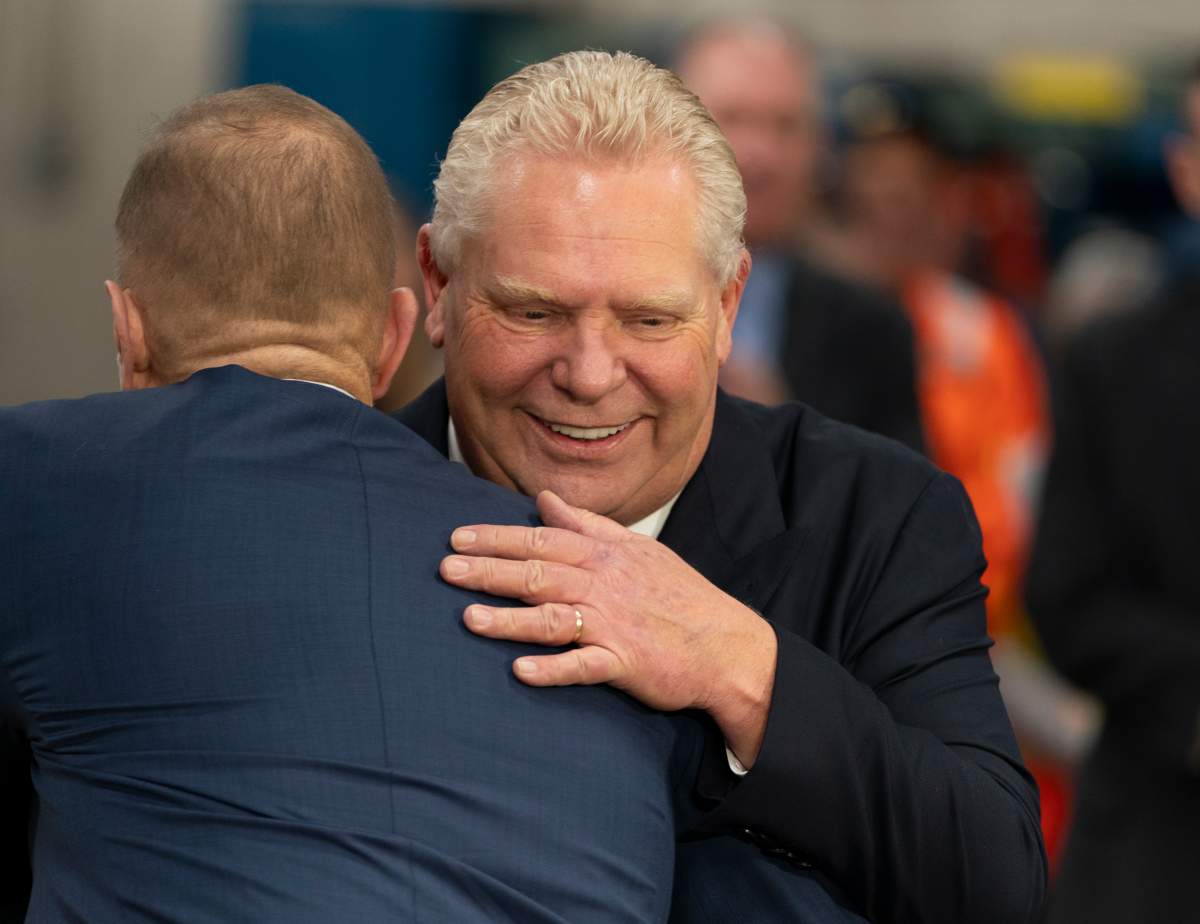 Progressive Conservative Leader Doug Ford is hugged by Niagara Falls Mayor Jim Diodati during a visit to Walker Construction in St. Catharines, Ont. on Friday, January 31, 2025. 