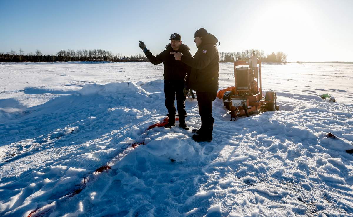 Manitoba Premier Wab Kinew, left, and Pimicikamak Cree Nation councillor David Muswagon talk about some of the difficulties the community faces after recent infrastructure failures during a tour with politicians and media at Pimicikamak Cree Nation, Man., on Wednesday, January 7, 2026.