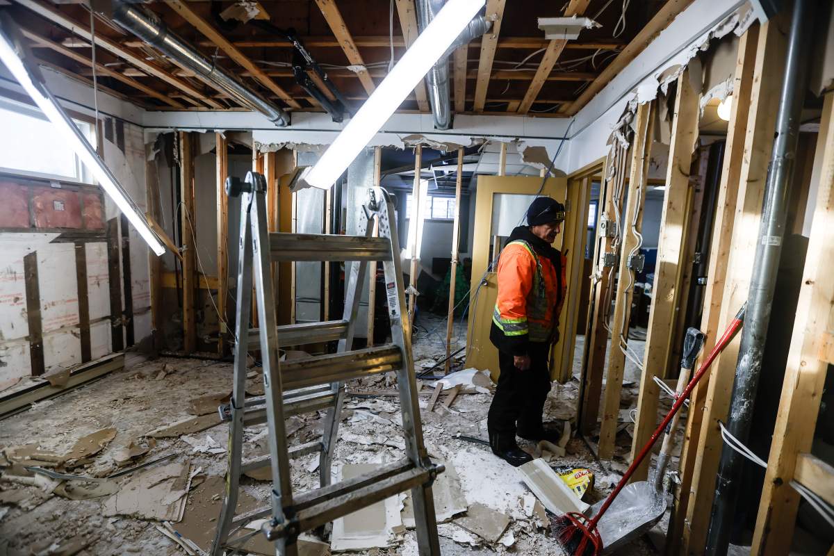 Crews work to clean up the basement of a home on the Pimicikamak Cree Nation which was destroyed due to water damage during recent infrastructure failures during a tour with politicians and media at Pimicikamak Cree Nation, Man., on Wednesday, January 7, 2026.