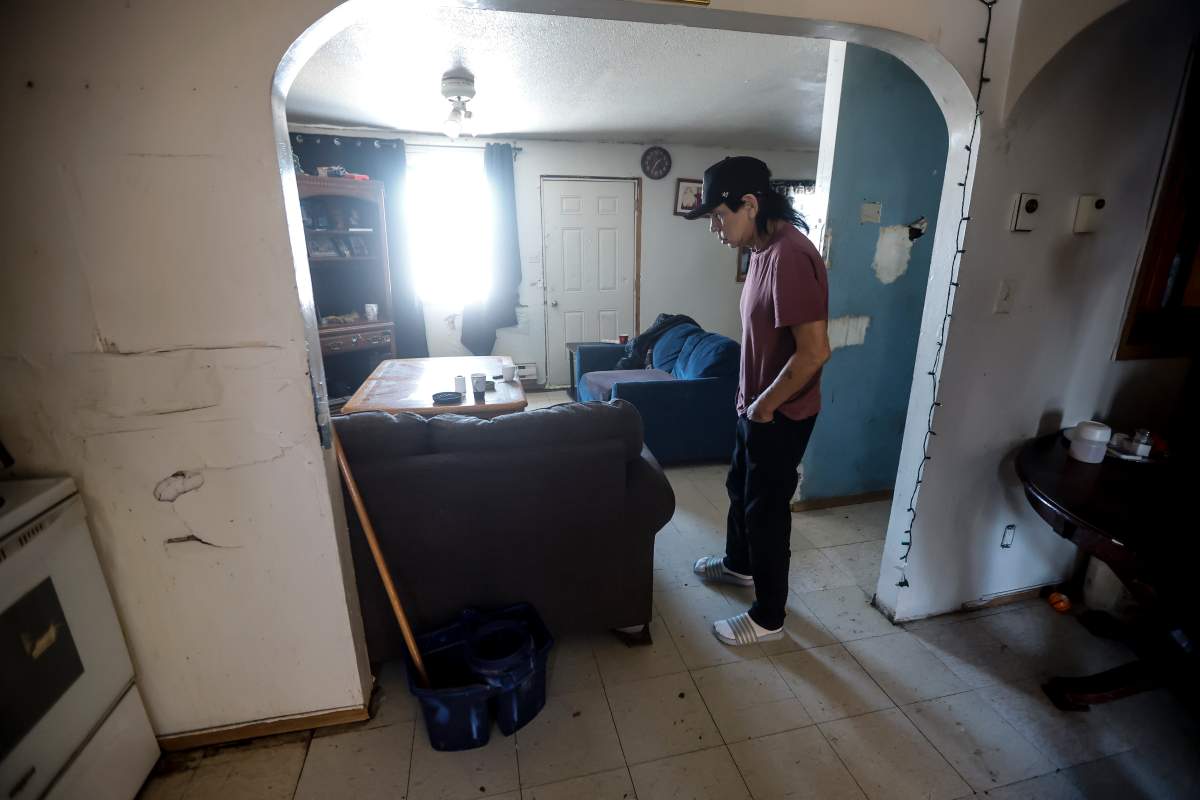 Murphy Trout stands in his home after showing media the damage from a water main break in his crawl space during a tour with politicians and media at Pimicikamak Cree Nation, Man., on Wednesday, January 7, 2026.