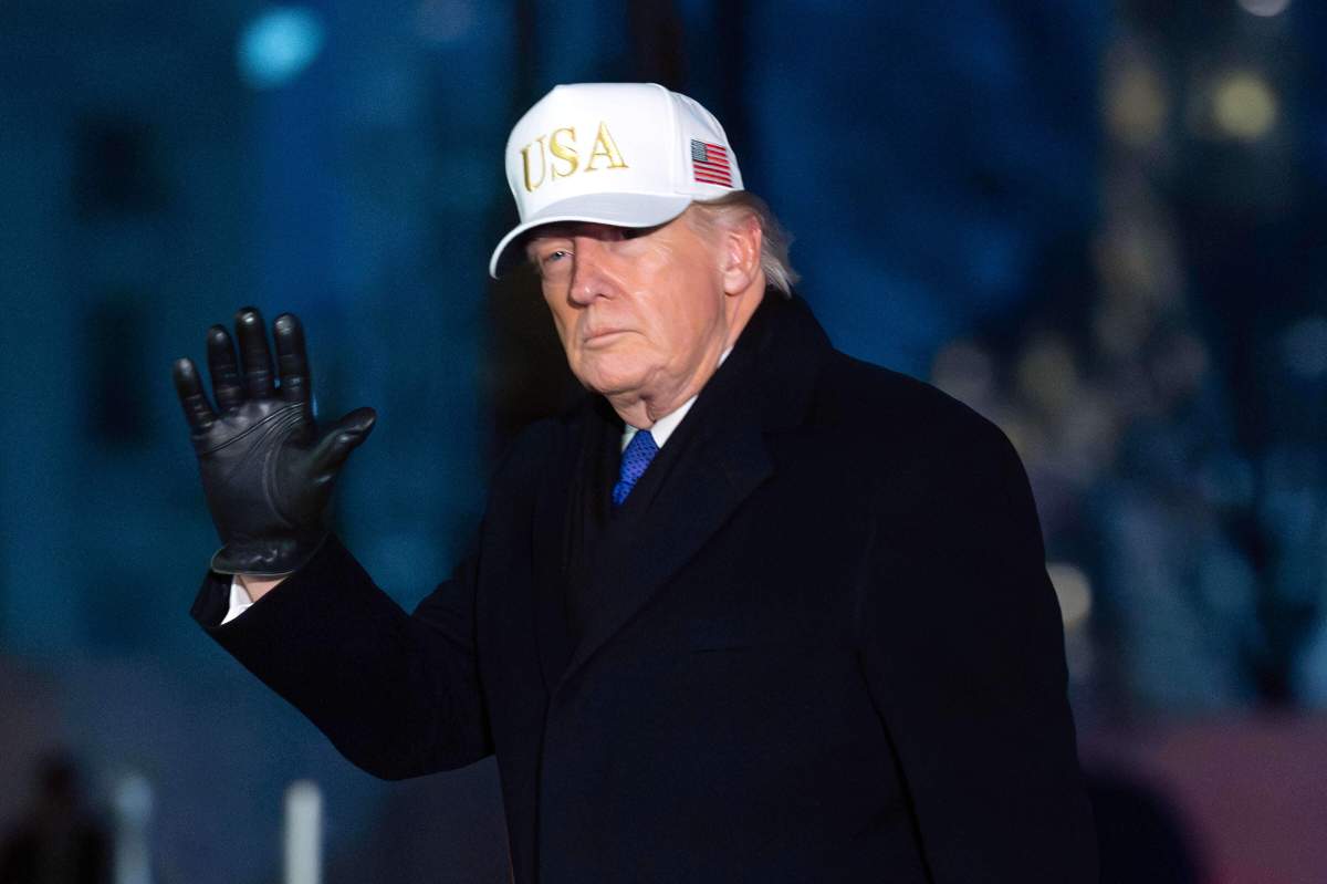 President Donald Trump waves to the media as he walks on the South Lawn of the White House, Sunday, Feb. 1, 2026, in Washington.
