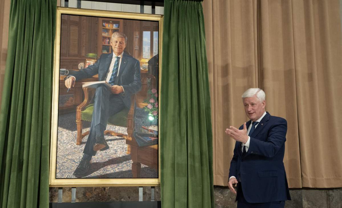 Former prime minister Stephen Harper gestures to the artist after he unveiled his official portrait during a ceremony in Ottawa, on Tuesday, Feb 3, 2026. THE CANADIAN PRESS/Adrian Wyld.