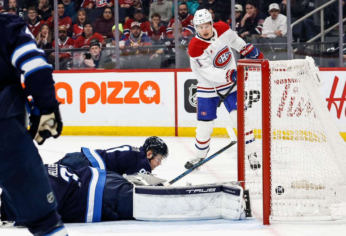 Montreal Canadiens' Oliver Kapanen (91) scores on Winnipeg Jets goaltender Connor Hellebuyck (37) during first period NHL action in Winnipeg, Wednesday, Feb. 4, 2026. THE CANADIAN PRESS/John Woods.