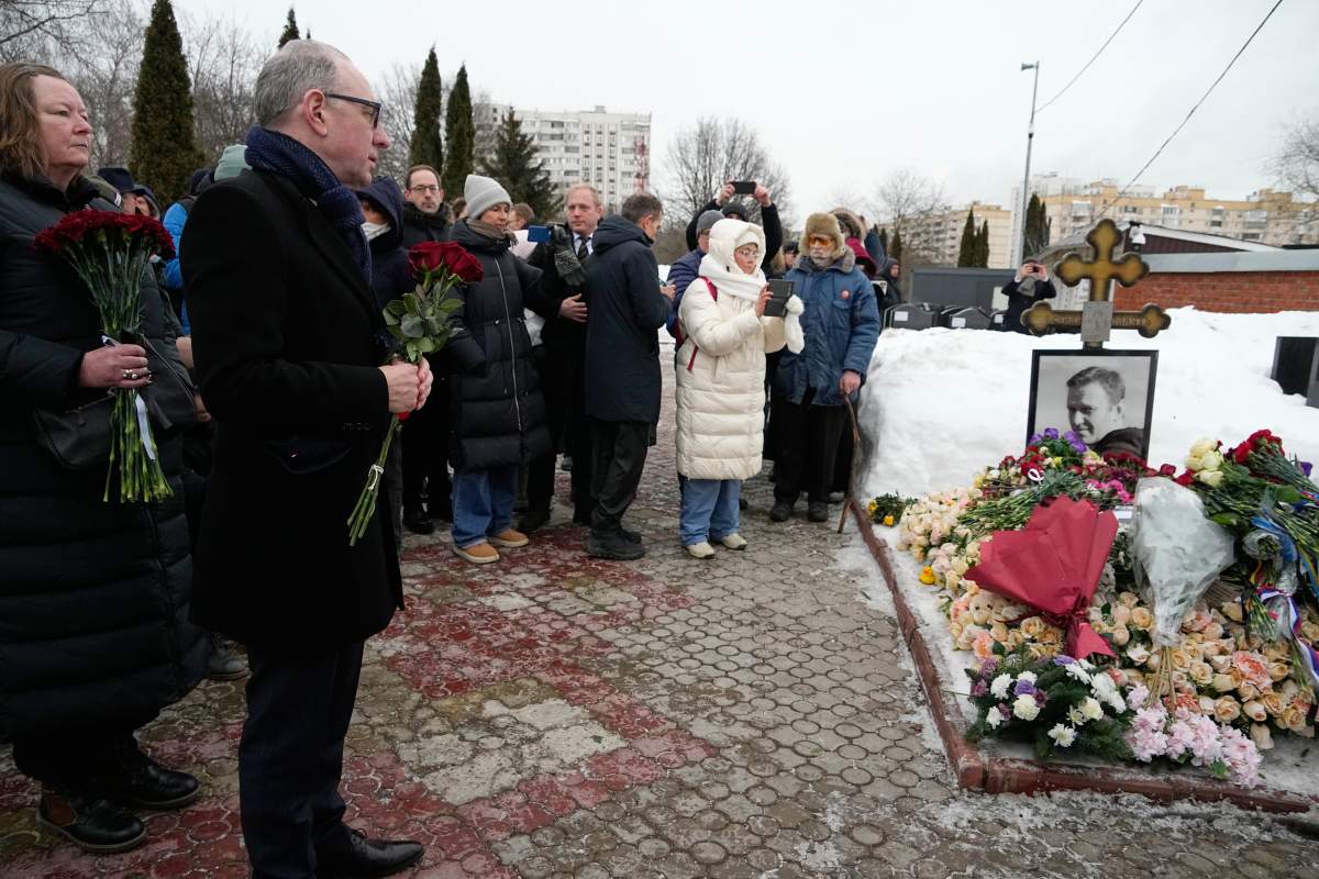 A group of ambassadors to Russia lay flowers at the grave of Russian opposition leader Alexei Navalny, two years after his death, at the Borisovskoye Cemetery in Moscow, on Monday, Feb. 16, 2026. (AP Photo/Alexander Zemlianichenko)