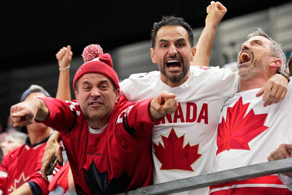 Canada supporters celebrate after Canada's Shea Theodore (27) scored his side's second goal during a men's ice hockey semifinal game between Canada and Finland at the 2026 Winter Olympics, in Milan, Italy, Friday, Feb. 20, 2026.