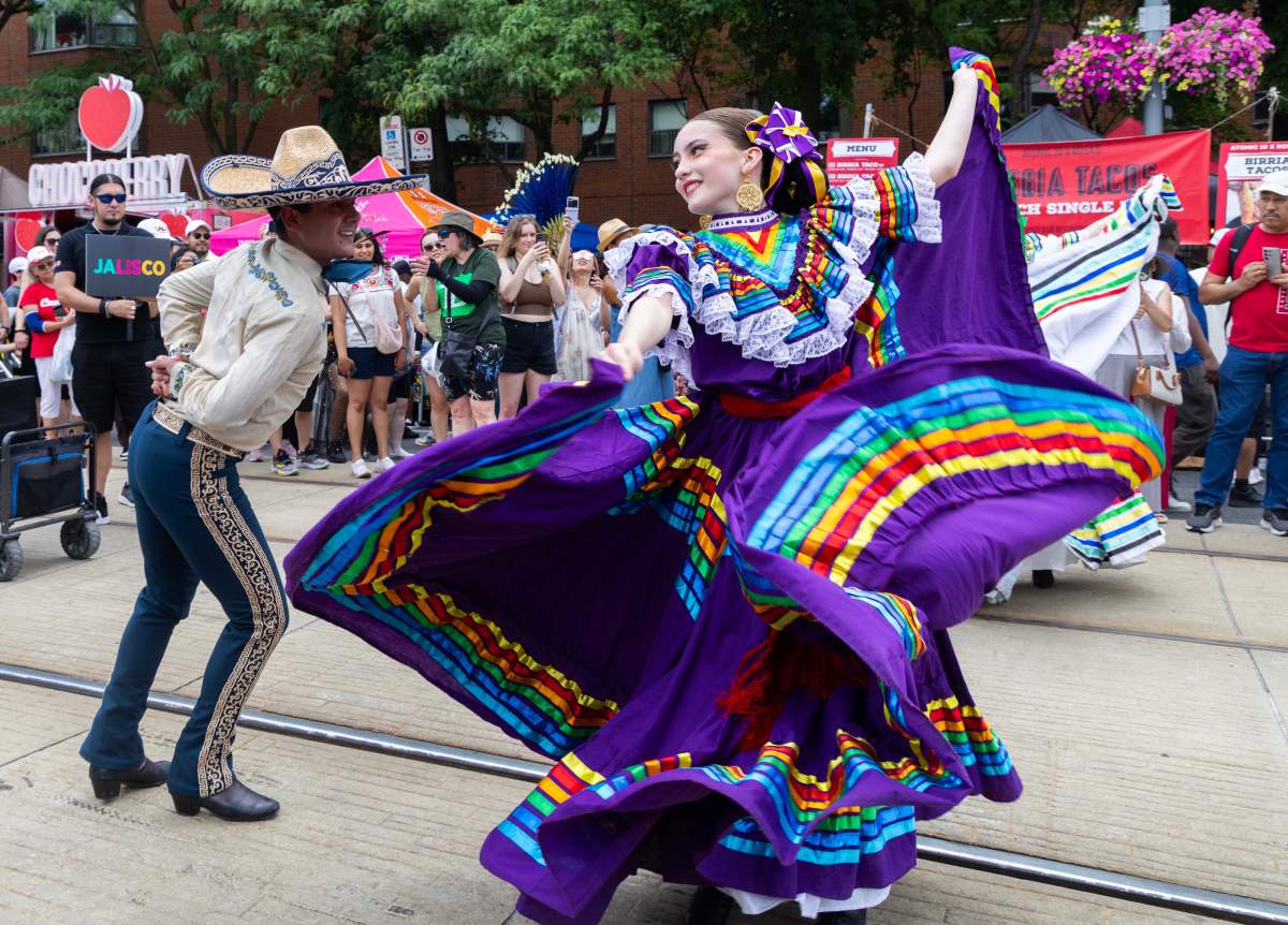 Dressed-up dancers take part in a dance parade during the 2025 Salsa on St. Clair Street Festival in Toronto, Canada, on July 5, 2025.