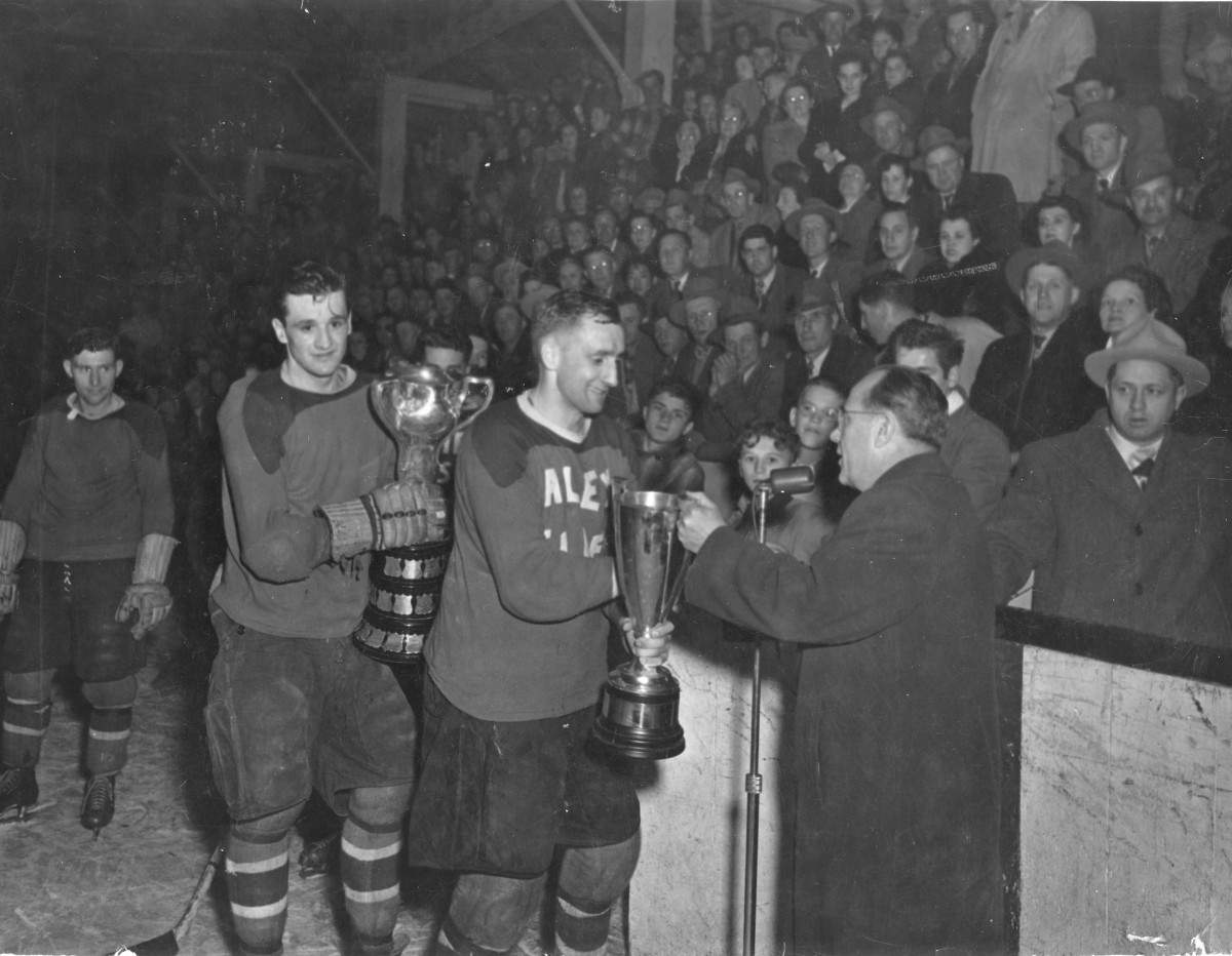 Billy Gibson holding the trophy, victorious at the 1952 Olympics