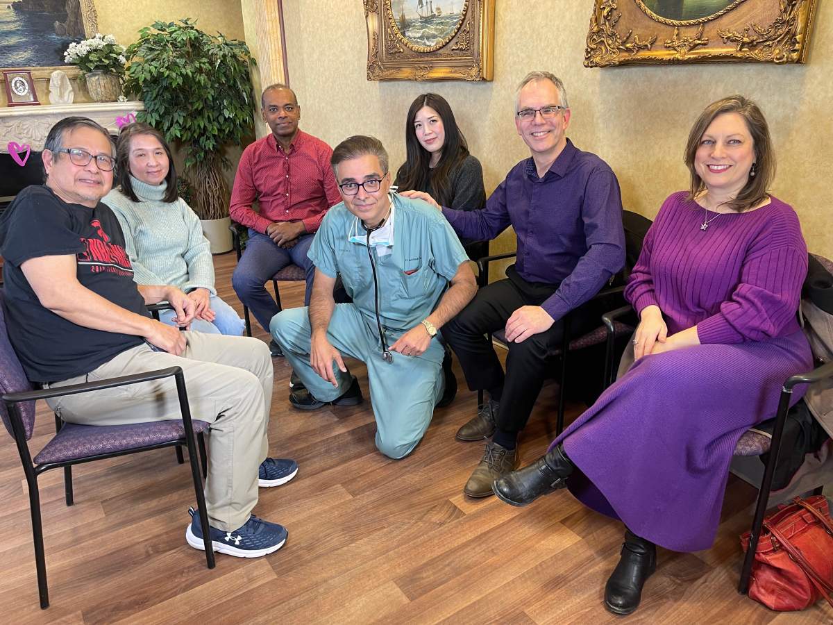 Dr. Subodh Verma poses with three patients he treated and their families in a waiting room at St. Michael's Hospital in Toronto, Ontario.