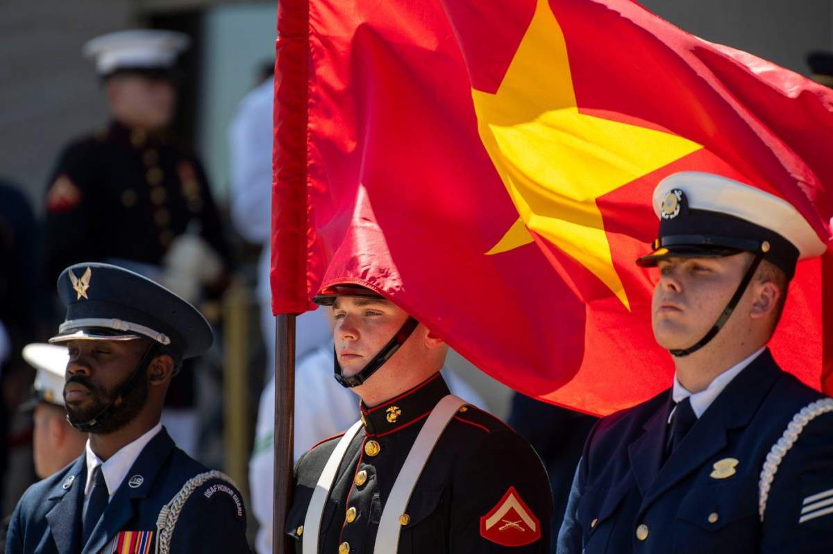 FILE – A U.S. Marine honor guard member holds the Vietnamese flag during an honor cordon at the Pentagon to welcome Vietnamese Defense Minister Gen. Phan Van Giang, Sept. 9, 2024, in Washington. (AP Photo/Kevin Wolf, File)