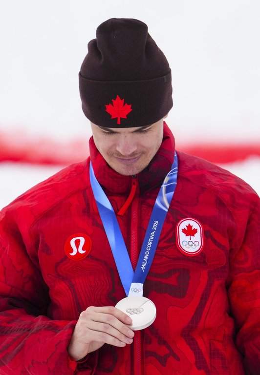 Mikael Kingsbury from Deux-Montagnes, Que., celebrates silver in the men's moguls at the Milano Cortina 2026 Winter Olympic Games in Livigno, Italy on Thursday, Feb. 12, 2026. THE CANADIAN PRESS/Sean Kilpatrick.