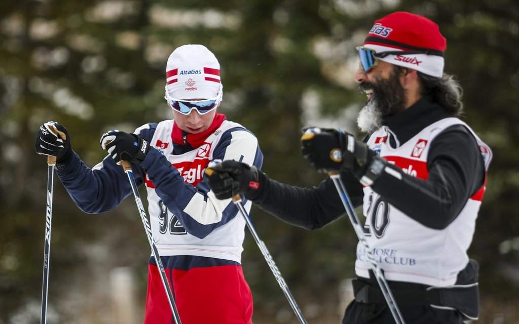Canadian Cross-Country Ski Team members Xavier McKeever, left, speaks with his uncle Brian McKeever as the pair take a break during early season training in Canmore, Alta., Monday, Oct. 19, 2020. THE CANADIAN PRESS/Jeff McIntosh.