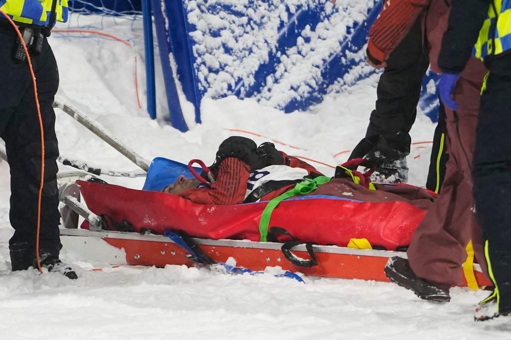 Medical personnel stretcher Canada's Mark McMorris off after crashing during a snowboard big air training session at the 2026 Winter Olympics, in Livigno, Italy, Wednesday, Feb. 4, 2026. (AP Photo/Lindsey Wasson).