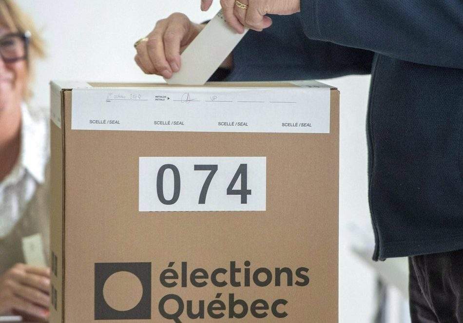A voter casts his ballot Monday, Oct. 1, 2018, in L'Assomption, Que., as Quebecers go to the polls in the provincial election. 