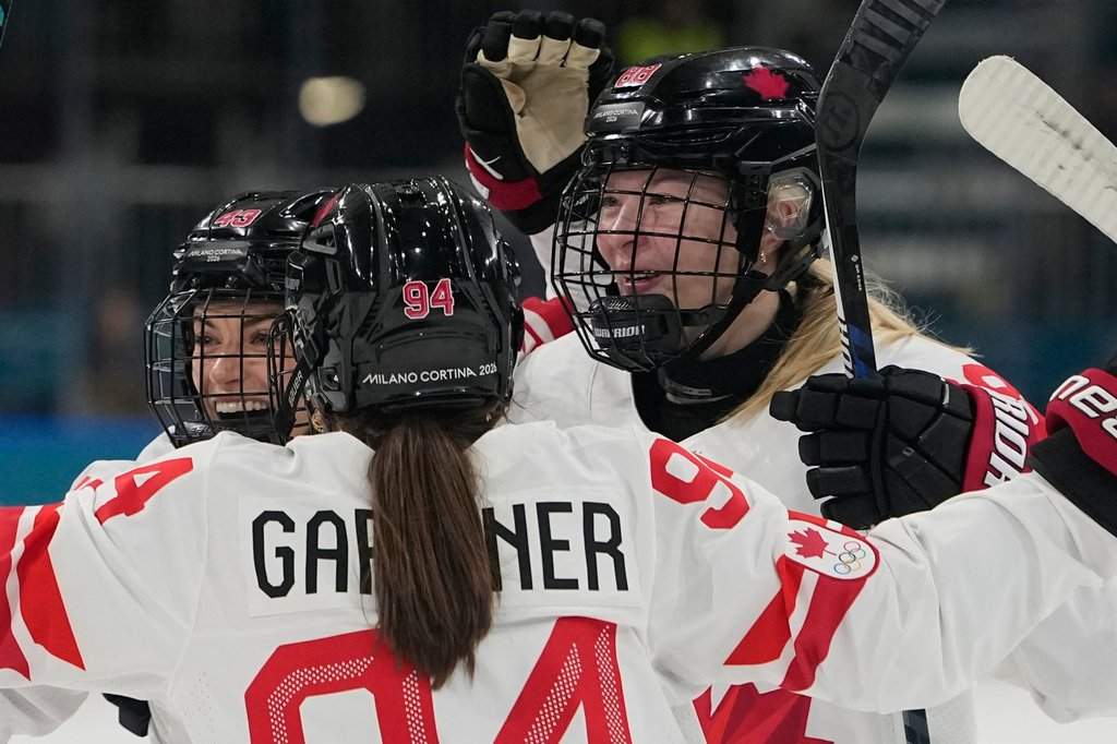 Canada's Kristin O'Neill, left, celebrates after scoring her side's third goal during a preliminary round match of women's ice hockey between Finland and Canada at the 2026 Winter Olympics, in Milan, Italy, Thursday, Feb. 12, 2026. (AP Photo/Hassan Ammar).