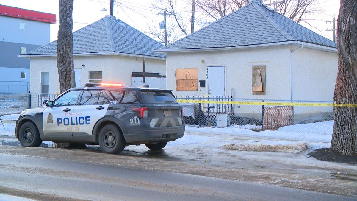 Police tape surrounds the house in Edmonton's Boyle-McCauley neighbourhood, following Monday's fatal fire.