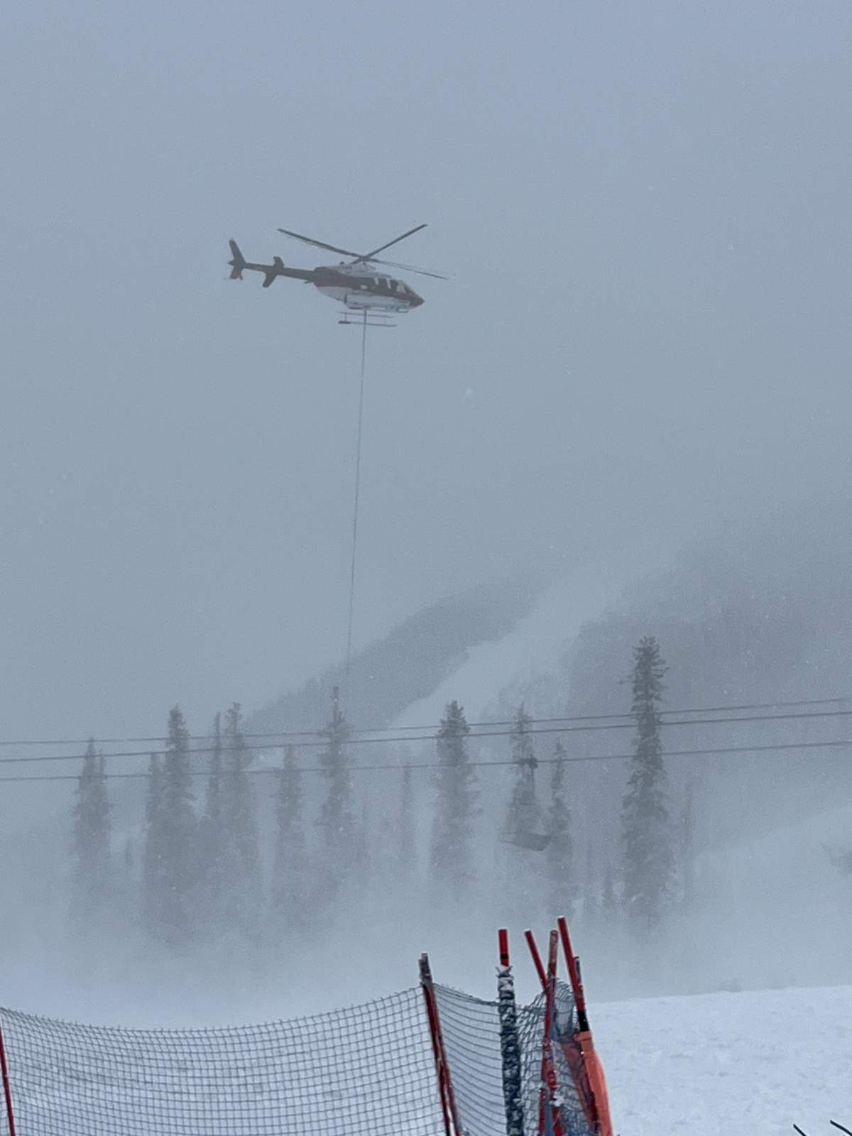 A photo provided by a viewer of one of the helicopters involved in Friday's rescue effort following an avalanche at the Nakiska ski area, west of Calgary.