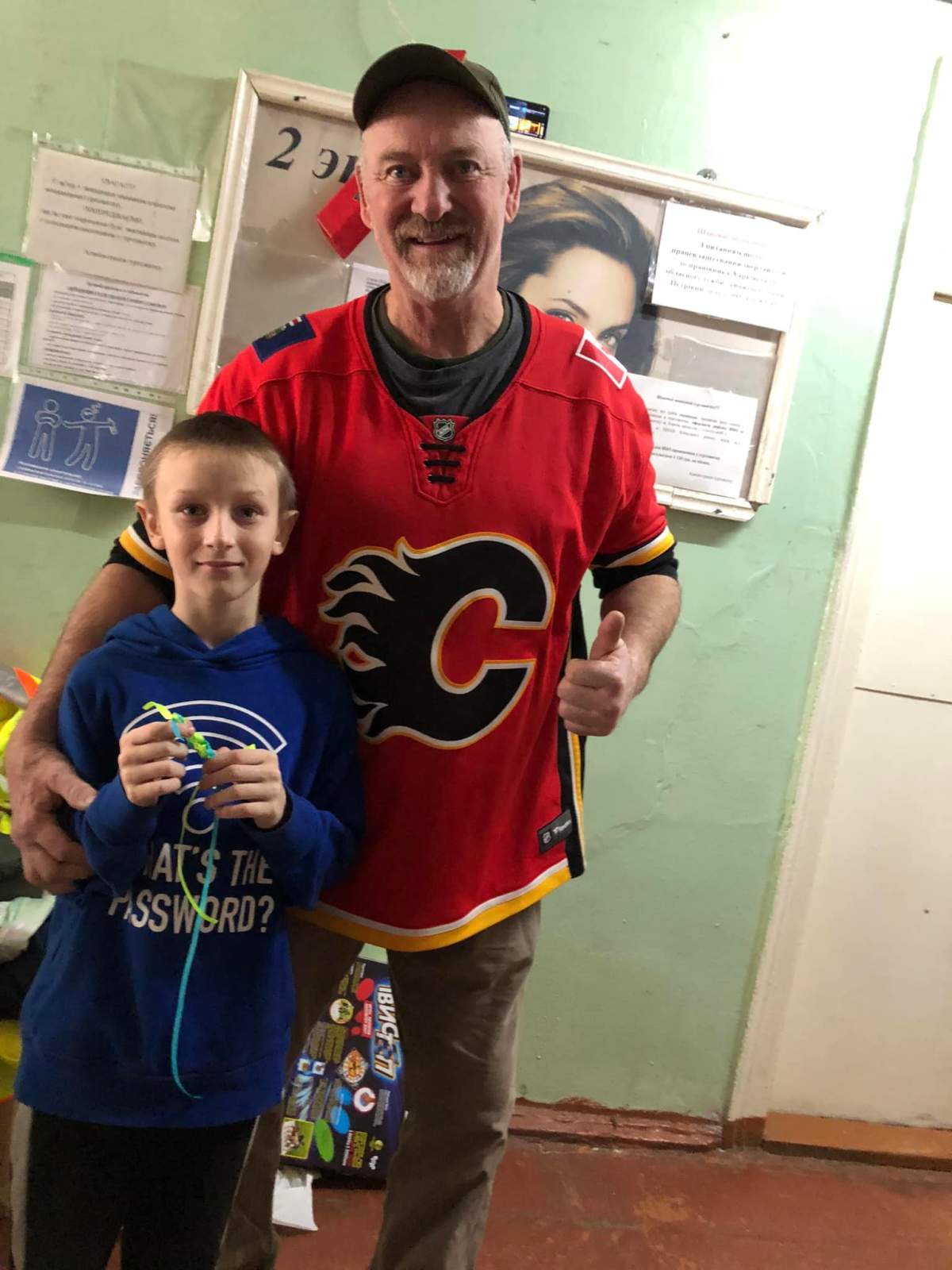 In his social media posts from the front lines of the war in Ukrain, Calgarian Paul Hughes, is often shown proudly wearing his Calgary Flames jersey.