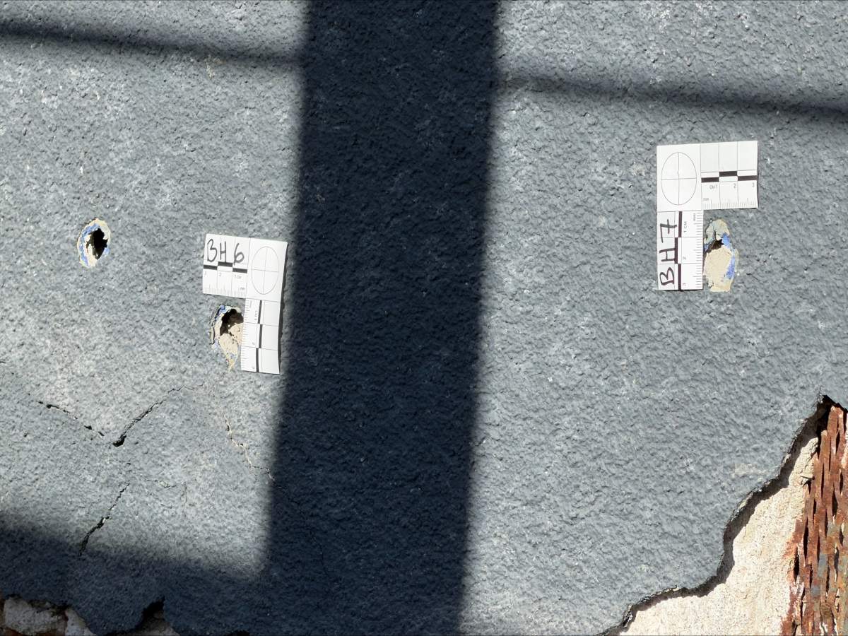 Bullet holes can be seen in the exterior of a building on Macleod Trail SE in Calgary, at the scene of shooting late Tuesday evening.