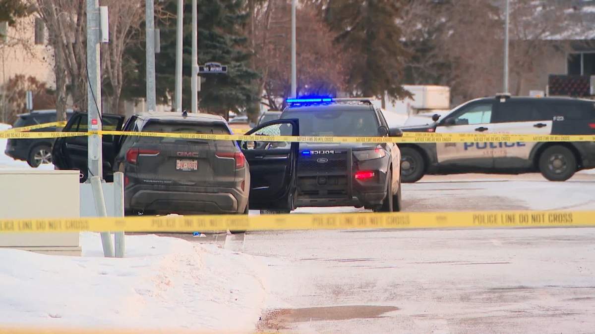 Police tape surrounds a vehicle at the scene of a fatal shooting in north Edmonton on Monday afternoon.