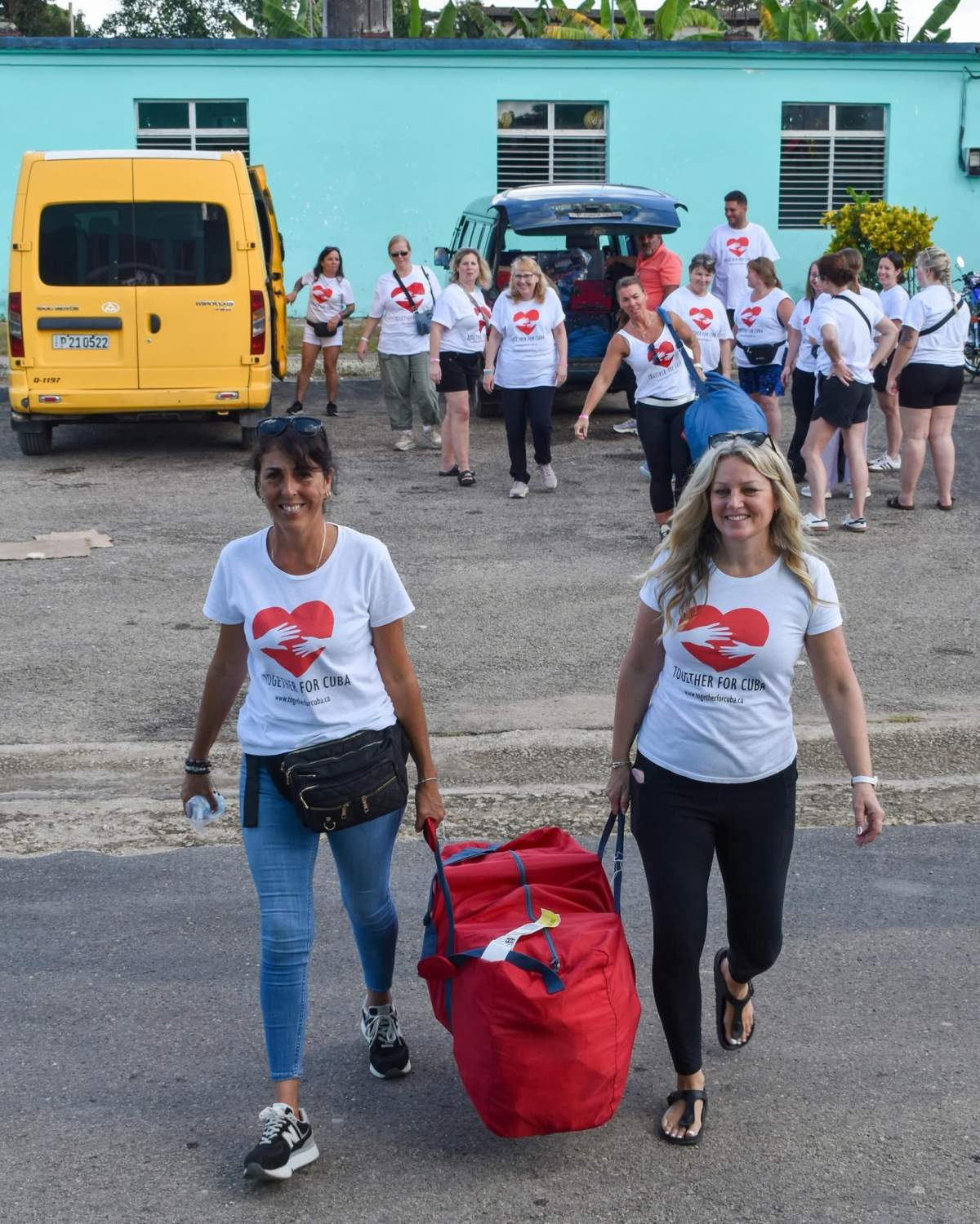 Jennifer Raymer, director of Together for Cuba, with a volunteer delivering duffel bags of aid to the Caribbean nation.