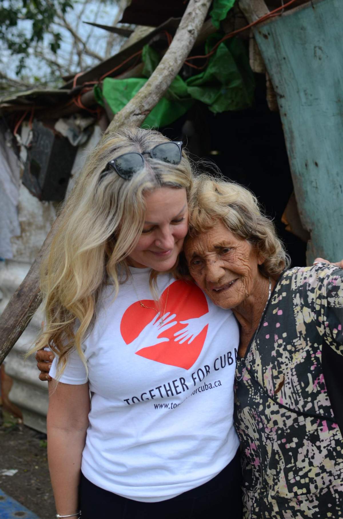 Jennifer Raymer, director of Together for Cuba, hugging a woman on the communist island nation.