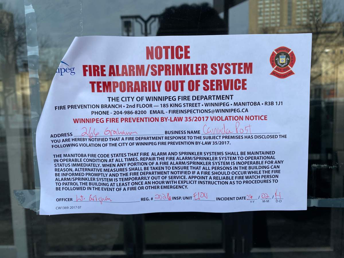A notice is posted on the Winnipeg Police Service headquarters on Feb. 15, 2026 after vandals opened water supply values, causing flooding in part of the building.