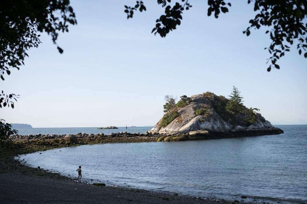 A swimmer stands along the shoreline at Whytecliff Park in West Vancouver, B.C,  on Thursday, July 18, 2024. THE CANADIAN PRESS/ Tijana Martin.