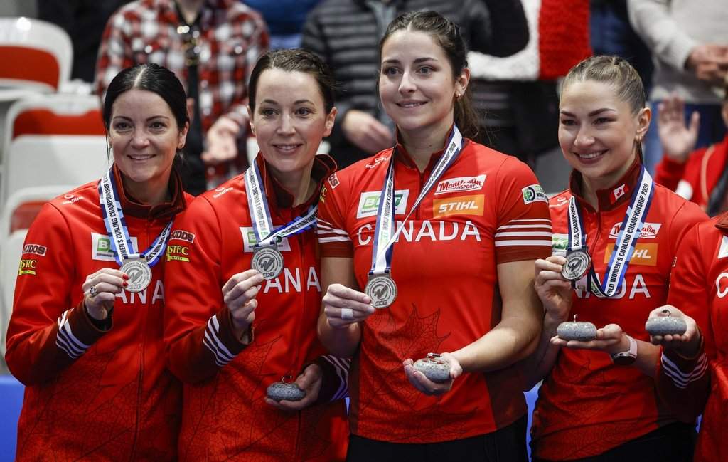 Canada skip Kerri Einarson, left to right, third Val Sweeting, second Shannon Birchard and lead Karlee Burgess hold their silver medals after losing the gold medal game to Switzerland at the World Women’s Curling Championship in Calgary, Sunday, March 22, 2026.  THE CANADIAN PRESS/Jeff McIntosh.
