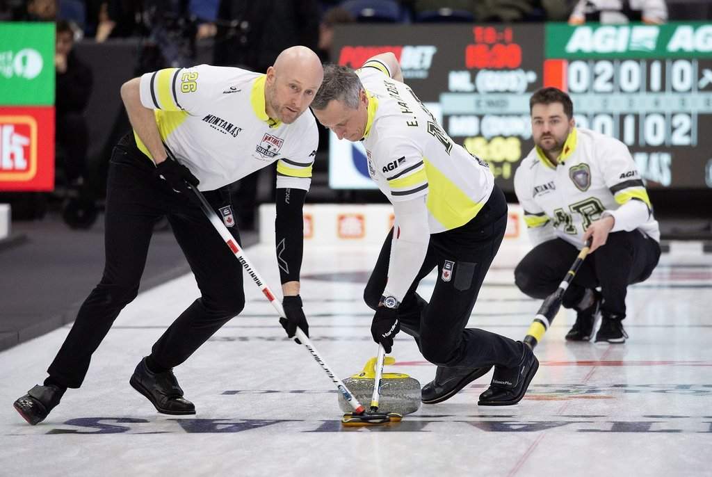 Ryan and E.J. Harnden of Team Manitoba-Dunstone sweep the stone just thrown by skip Matt Dunstone during Page 1 vs. 2 qualifiers at the Montana's Brier Canadian men's curling championship, in St. John's, N.L., on Friday, March 6, 2026. THE CANADIAN PRESS/Paul Daly.