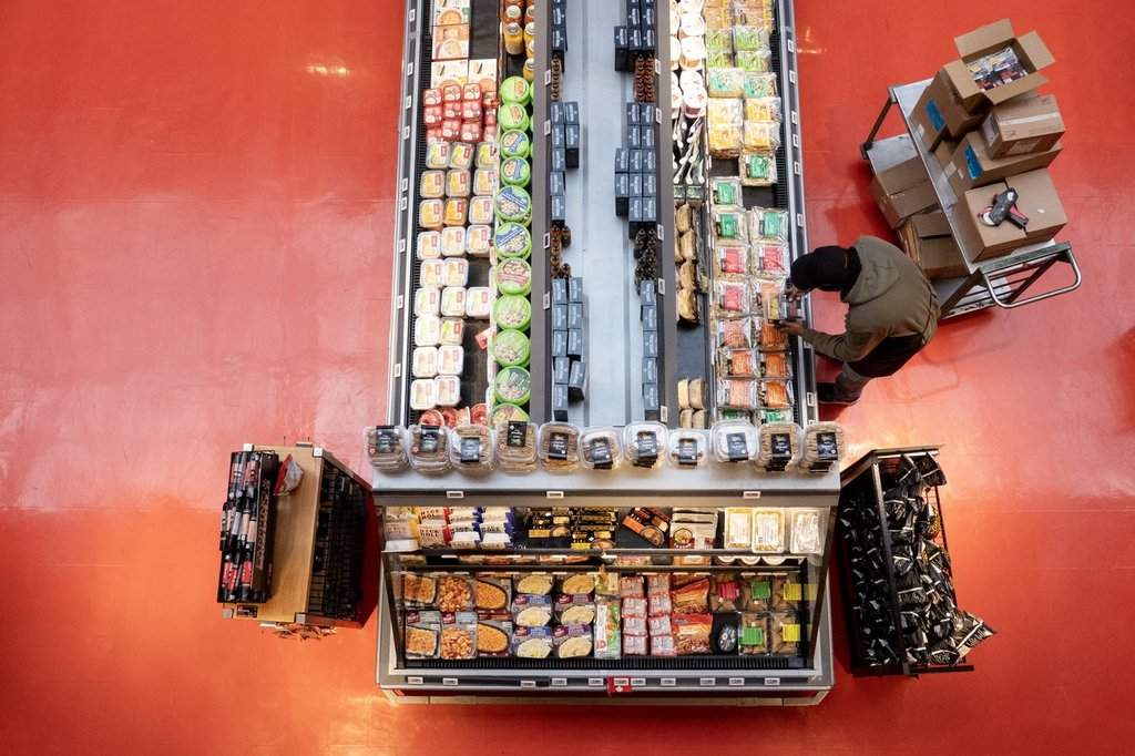 An employee stocks a display at a grocery store in Toronto on Thursday, March 12, 2026. THE CANADIAN PRESS/Chris Young.